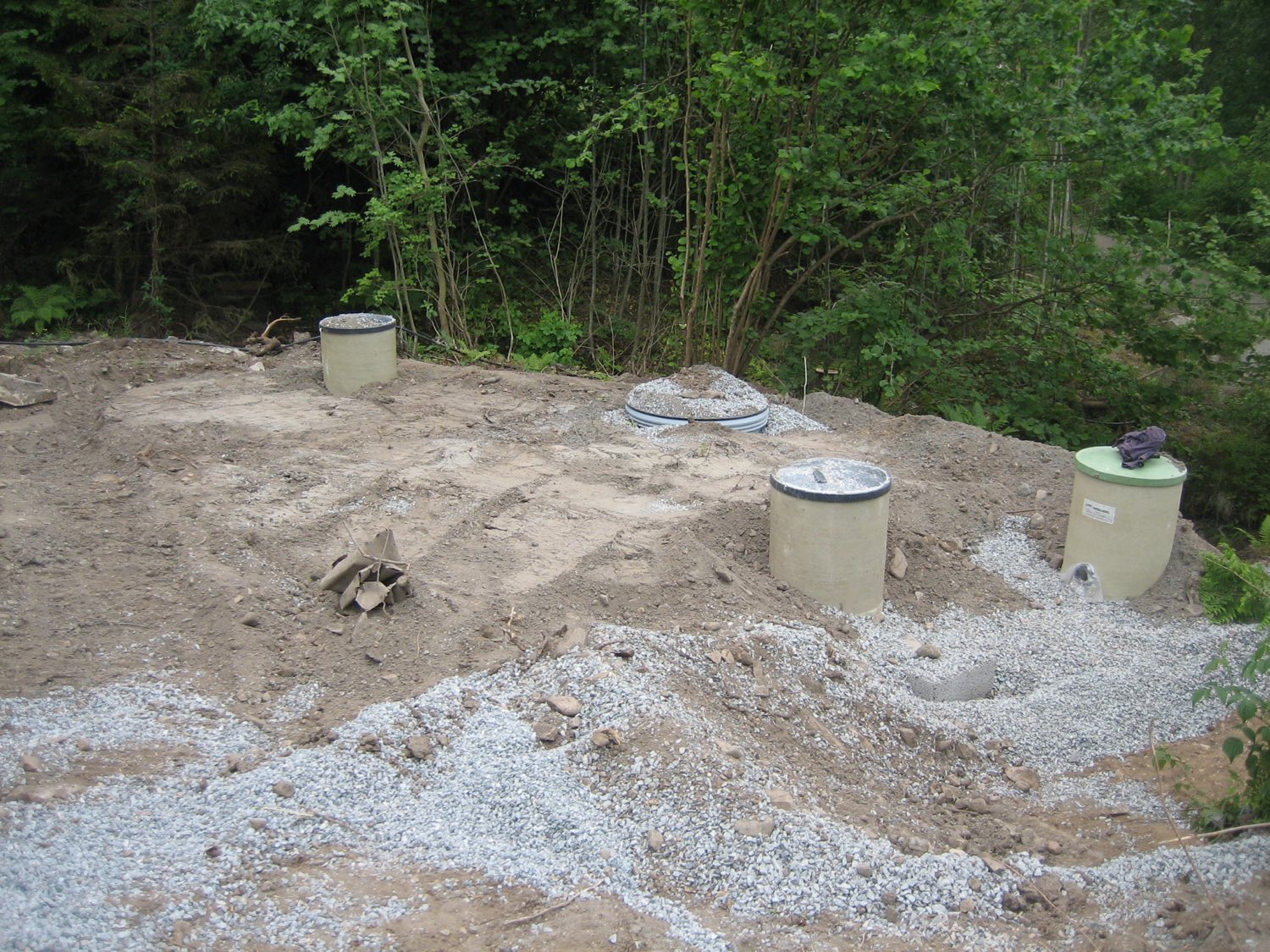 Septic tank risers and lids finished at ground level on a new system